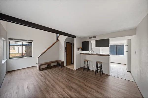 a view of kitchen with microwave and wooden floor