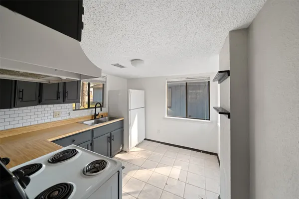 a view of a kitchen with a sink and living room