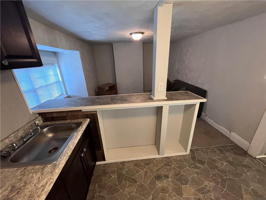 725 Clarissa Street Pittsburgh, PA 15219 - Photo 13 of 17 a kitchen with a stove and a microwave