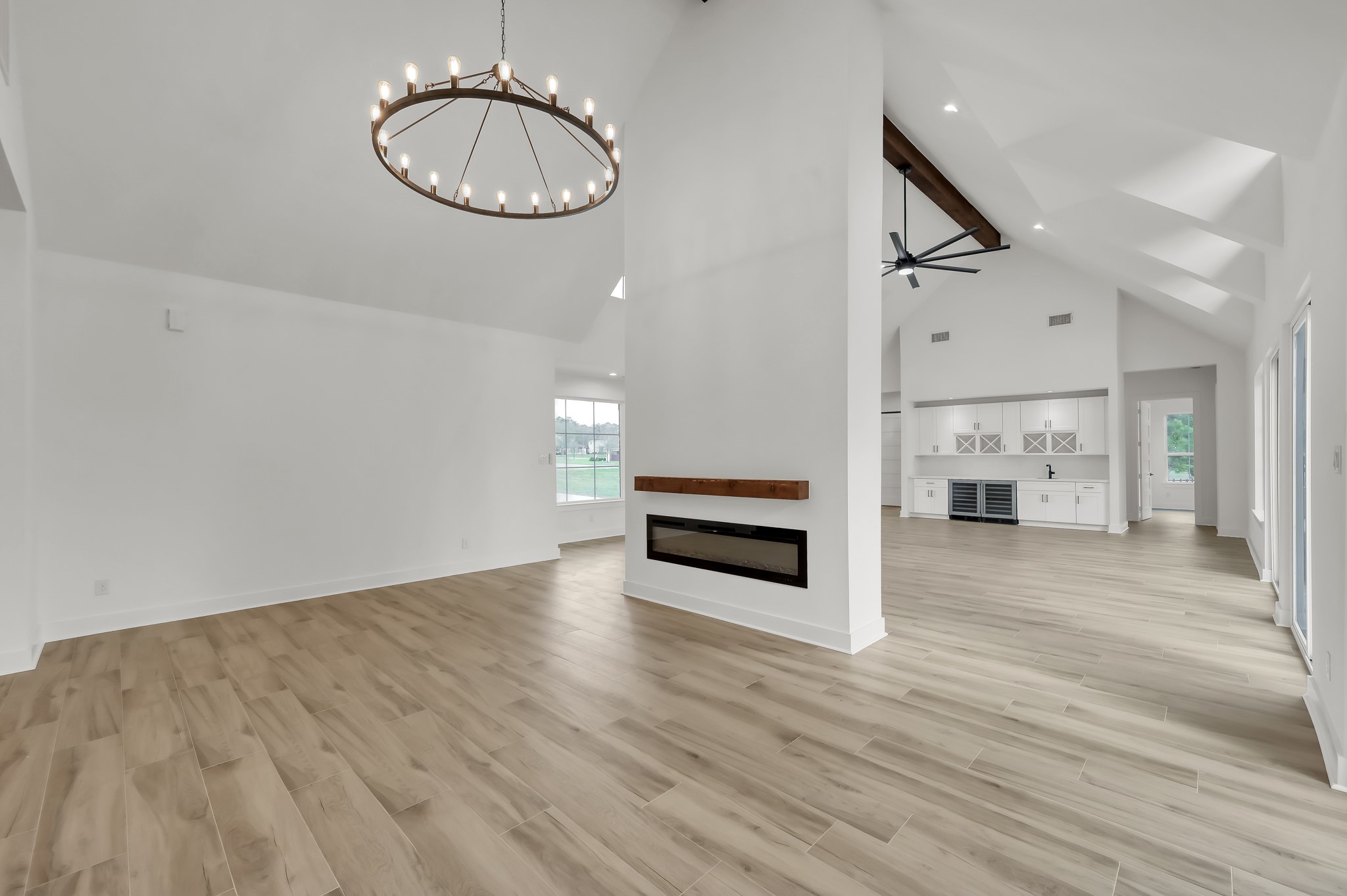 14742 Turquoise Trail Willis, TX 77378 - Photo 11 of 48 Elegant dining area highlighted by a dramatic chandelier and positioned adjacent to the double-sided fireplace. The open layout seamlessly connects dining, living, and kitchen spaces.