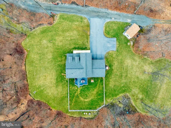 a kitchen with stainless steel appliances granite countertop a refrigerator a sink a stove a microwave oven a sink with island and chairs