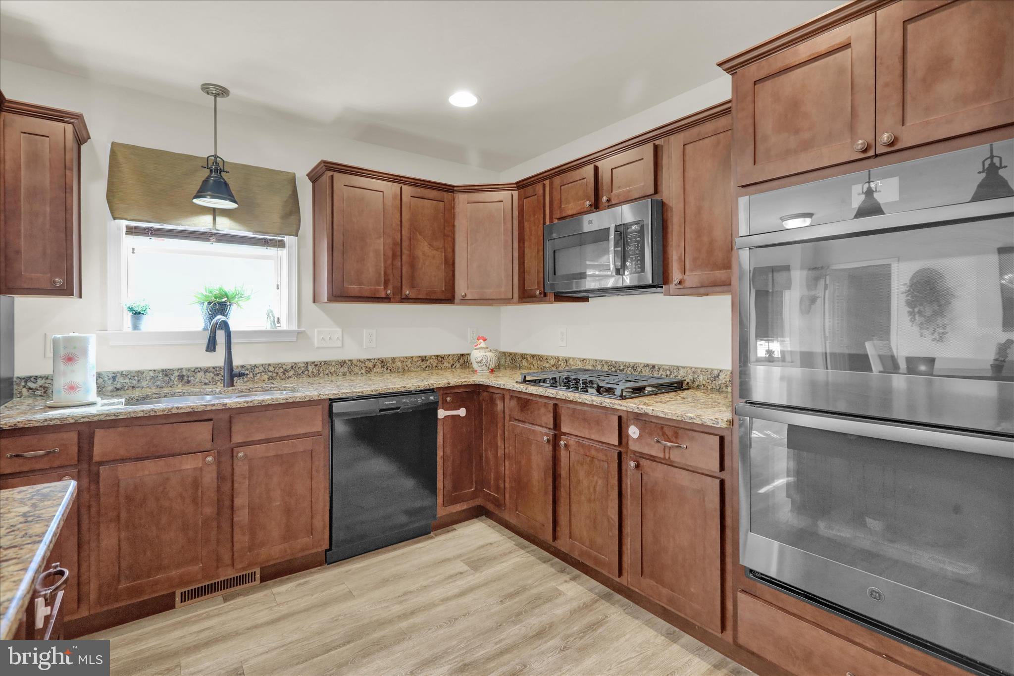 402 Mountainside Road Temple, PA 19560 - Photo 24 of 75 a kitchen with stainless steel appliances granite countertop a stove a sink and a microwave