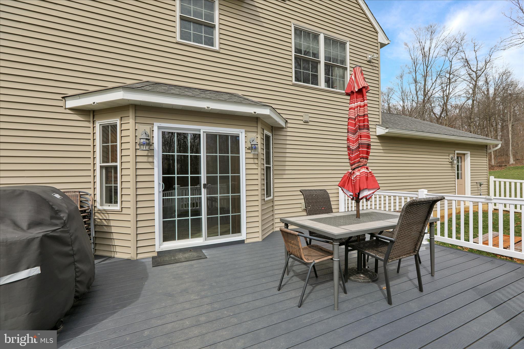 402 Mountainside Road Temple, PA 19560 - Photo 50 of 75 a view of a deck with a table and chairs and wooden floor