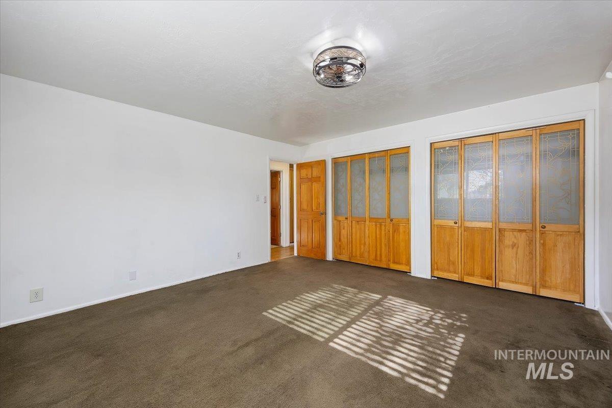 305 Lucille Street Kimberly, ID 83341 - Photo 20 of 36 Unfurnished bedroom featuring carpet and two closets