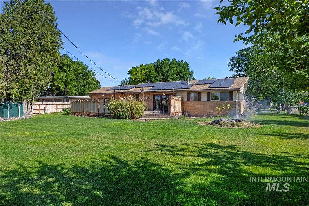 305 Lucille Street Kimberly, ID 83341 - Photo 29 of 36 Rear view of property featuring solar panels and brick siding