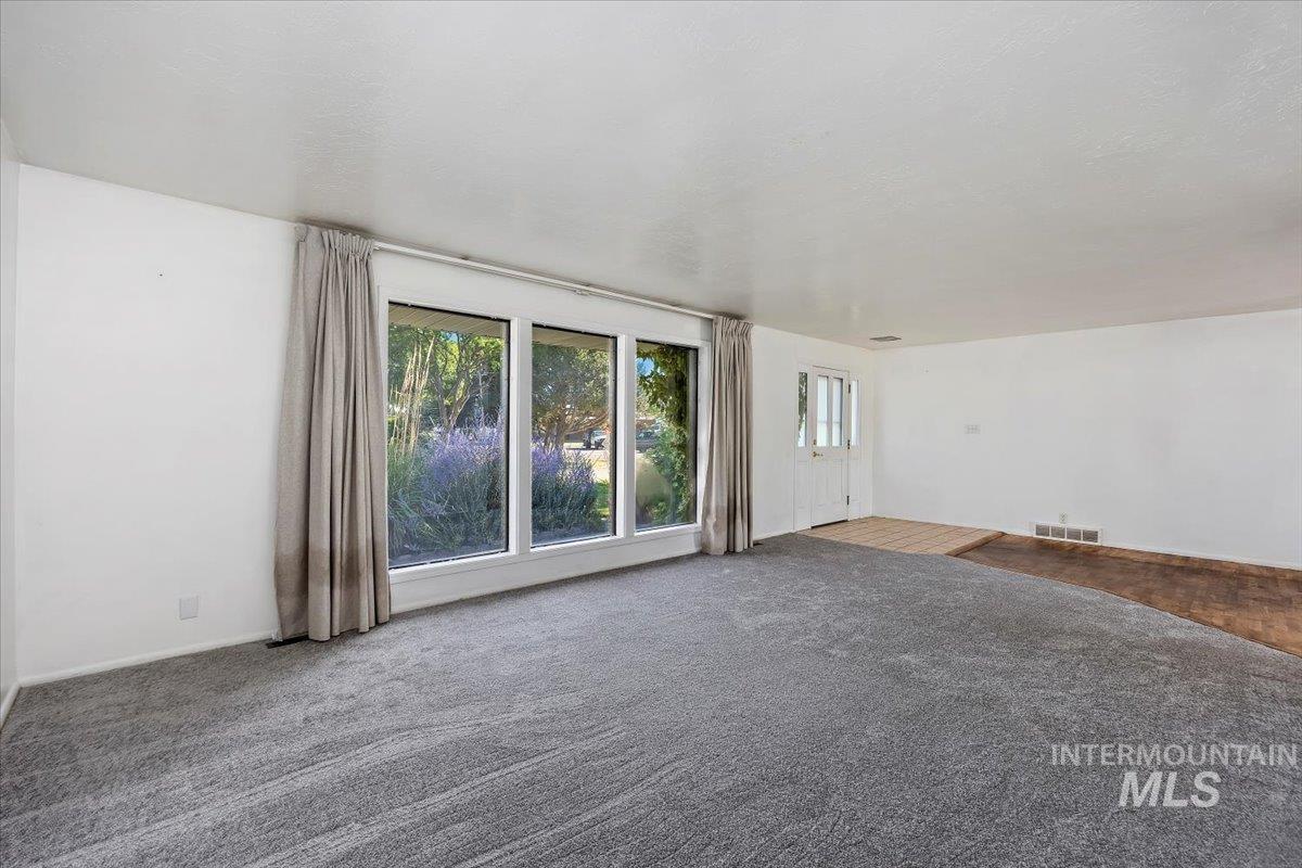 305 Lucille Street Kimberly, ID 83341 - Photo 8 of 36 Unfurnished living room featuring carpet flooring