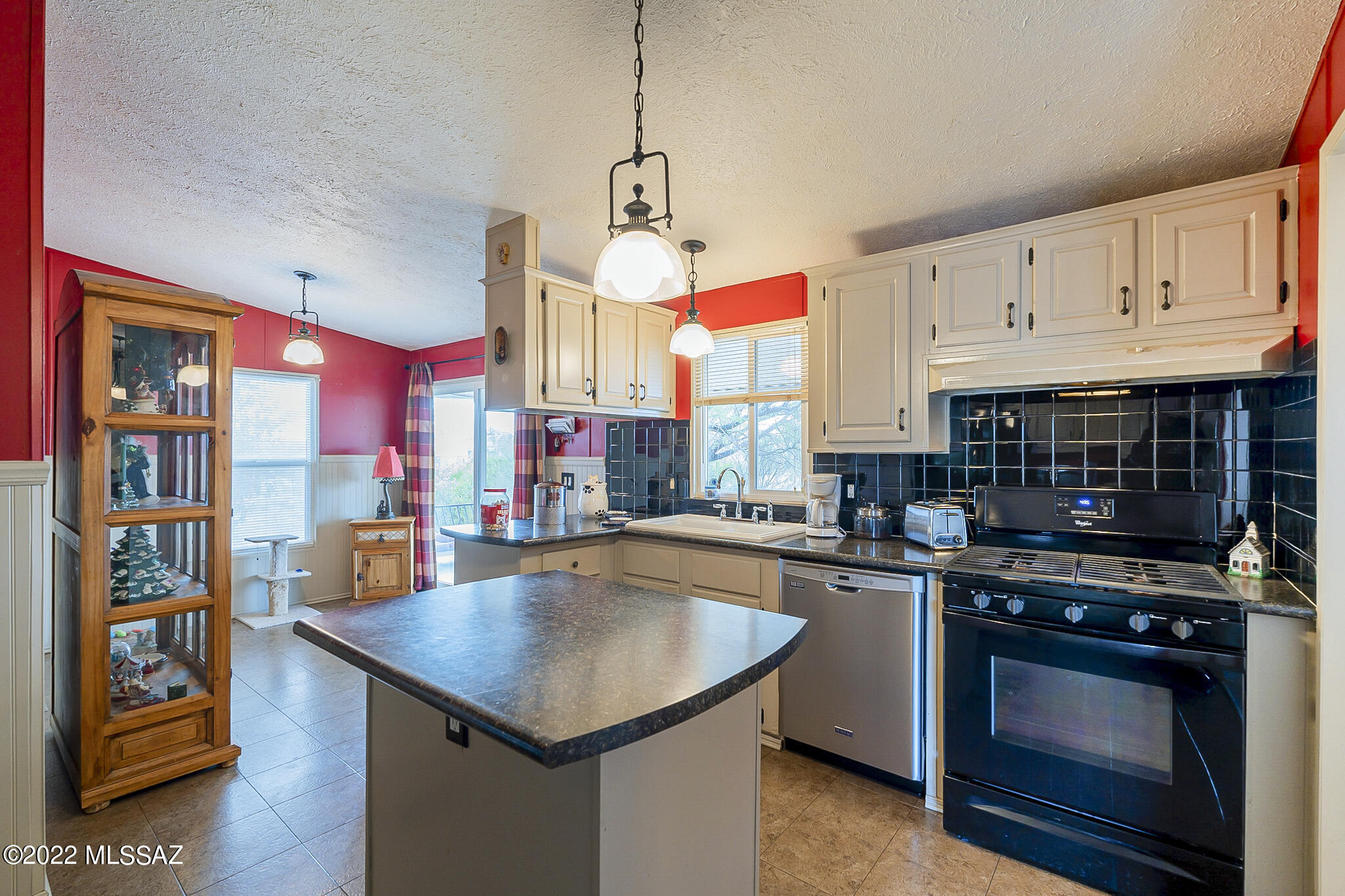 5285 North Puma Road Marana, AZ 85653 - Photo 12 of 46 a kitchen with stainless steel appliances granite countertop a stove a sink and a refrigerator