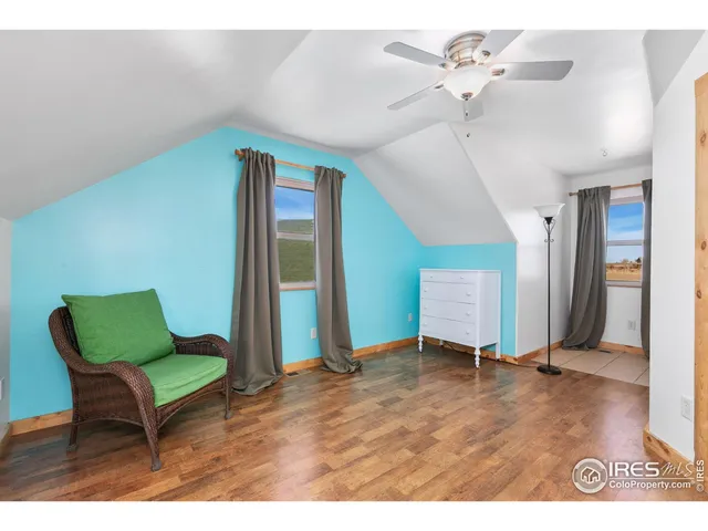 a view of a livingroom with furniture and a ceiling fan