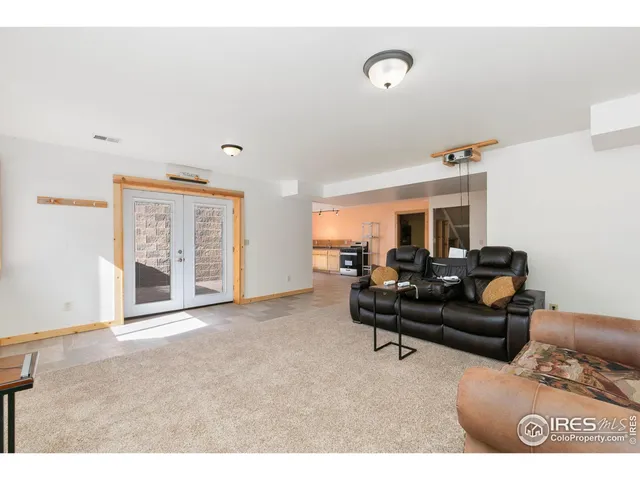 a living room with furniture and a gym machine
