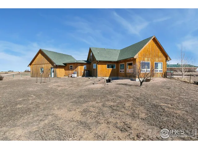 a view of house with outdoor space and sitting area