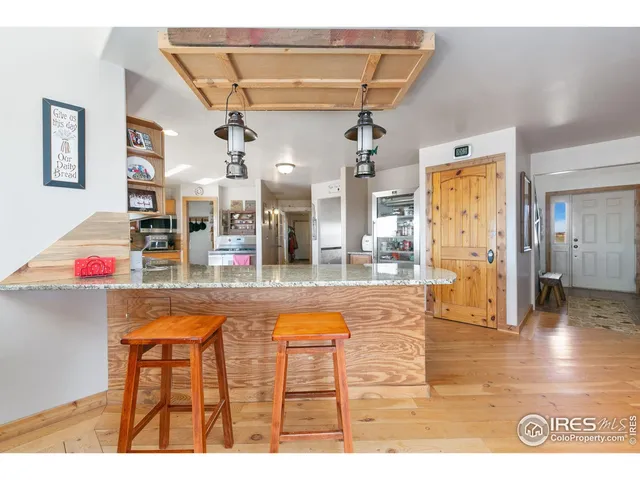 a view of a living room and kitchen