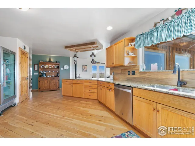 a kitchen with stainless steel appliances granite countertop a sink and cabinets