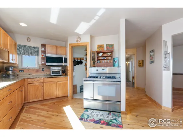 a kitchen with stainless steel appliances kitchen island granite countertop a refrigerator oven a sink and dishwasher