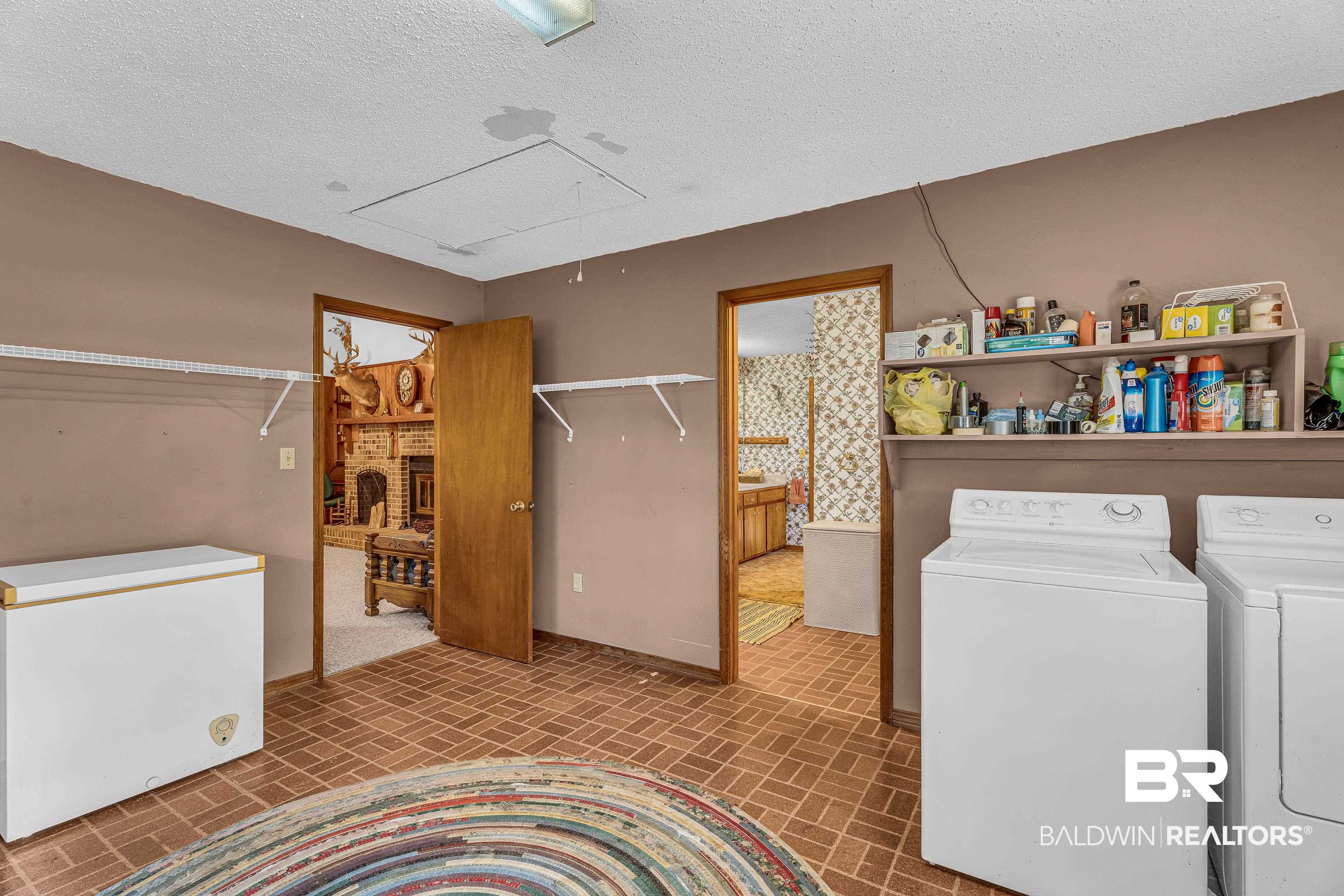 72075 Highway 59 Little River, AL 36550 - Photo 26 of 40 Laundry room featuring brick patterned floors, separate washer and dryer, a textured ceiling, and attic access