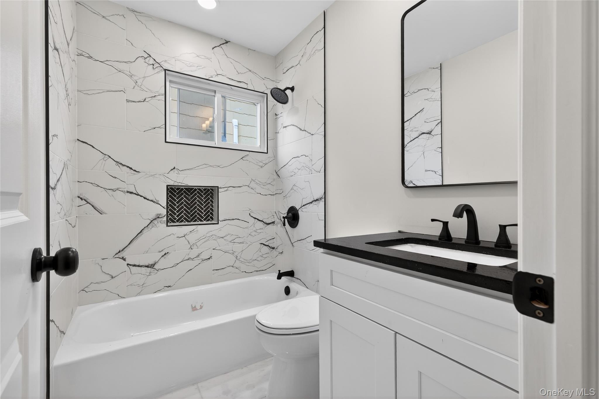 15 Lindsay Street Huntington, NY 11743 - Photo 17 of 23 a bathroom with a granite countertop sink a toilet and a bathtub
