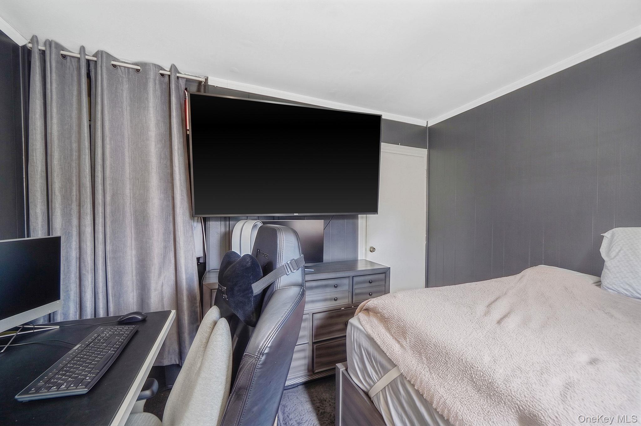 85 Applegate Drive Central Islip, NY 11722 - Photo 12 of 33 a bedroom with a bed and a flat screen tv