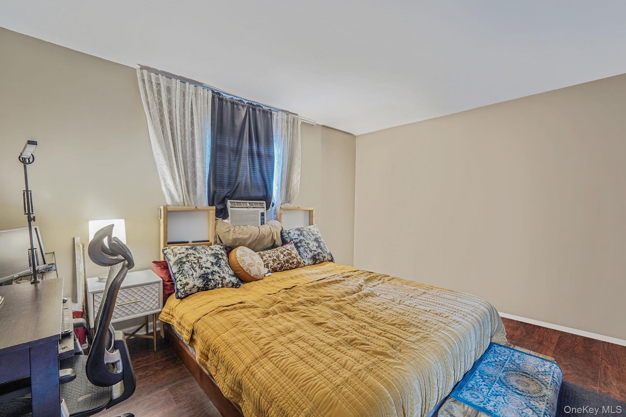 85 Applegate Drive Central Islip, NY 11722 - Photo 13 of 33 a bedroom with a bed and wooden floor
