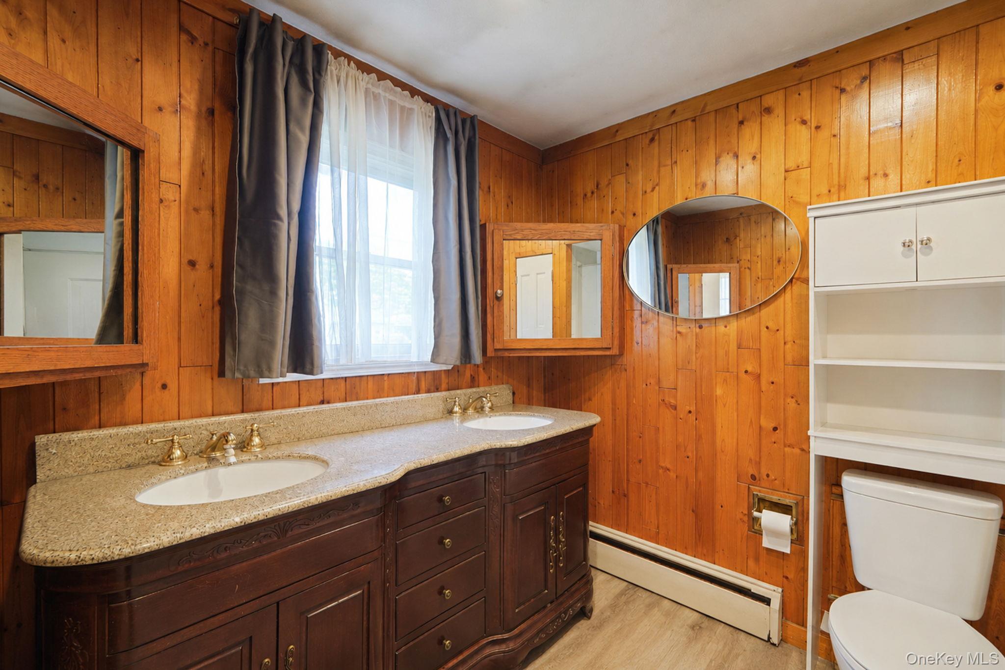 85 Applegate Drive Central Islip, NY 11722 - Photo 16 of 33 a bathroom with a granite countertop sink and a mirror
