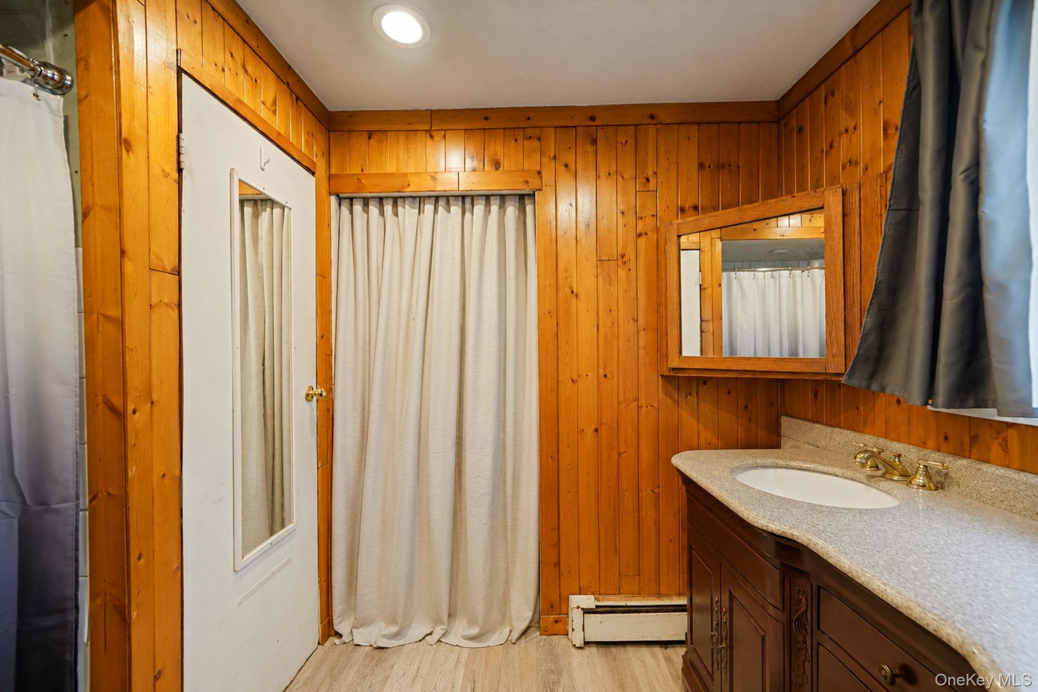 85 Applegate Drive Central Islip, NY 11722 - Photo 18 of 33 a bathroom with a double vanity sink and a mirror