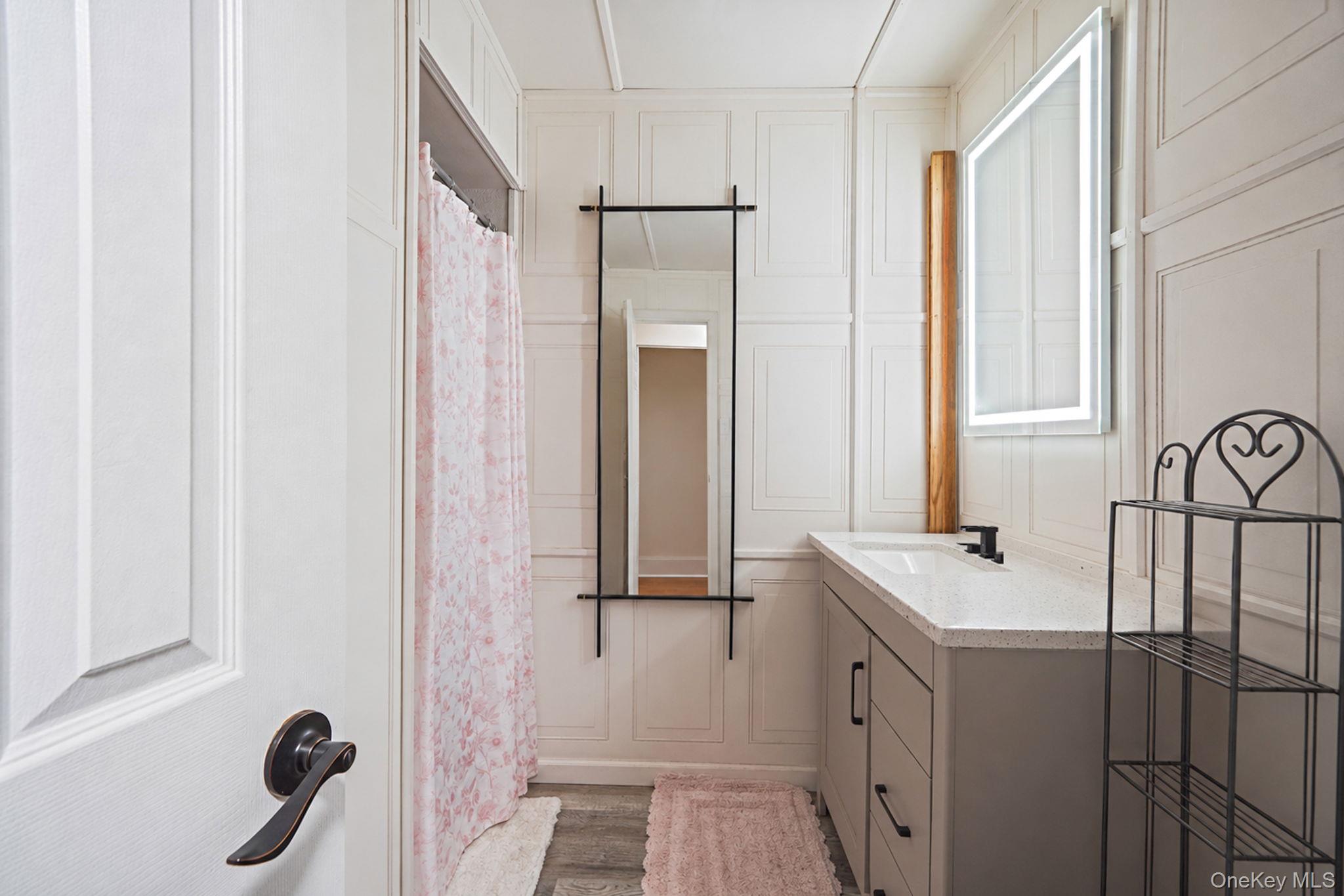85 Applegate Drive Central Islip, NY 11722 - Photo 20 of 33 a bathroom with a sink a mirror and shower