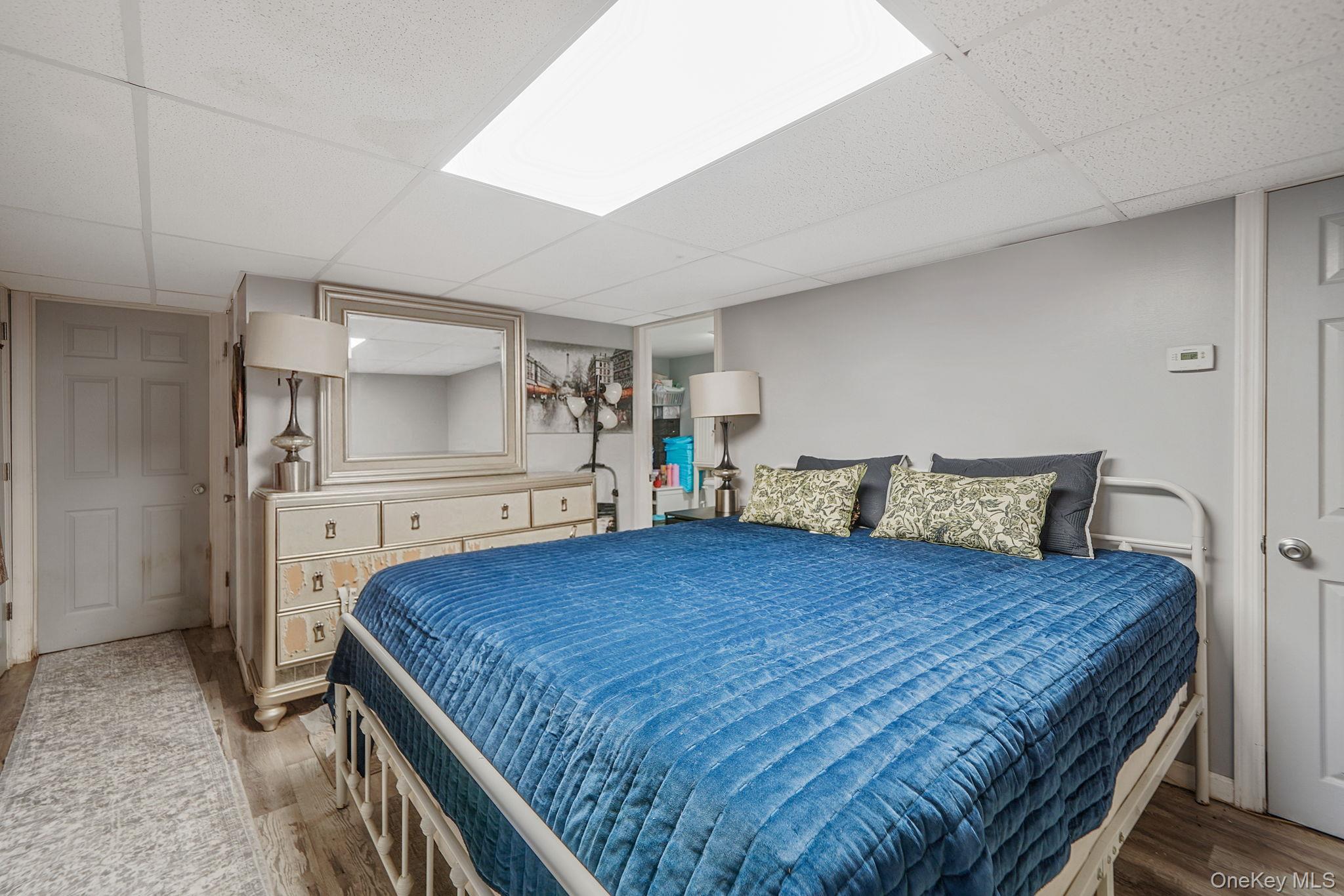 85 Applegate Drive Central Islip, NY 11722 - Photo 24 of 33 a bedroom with a large bed and a view of kitchen