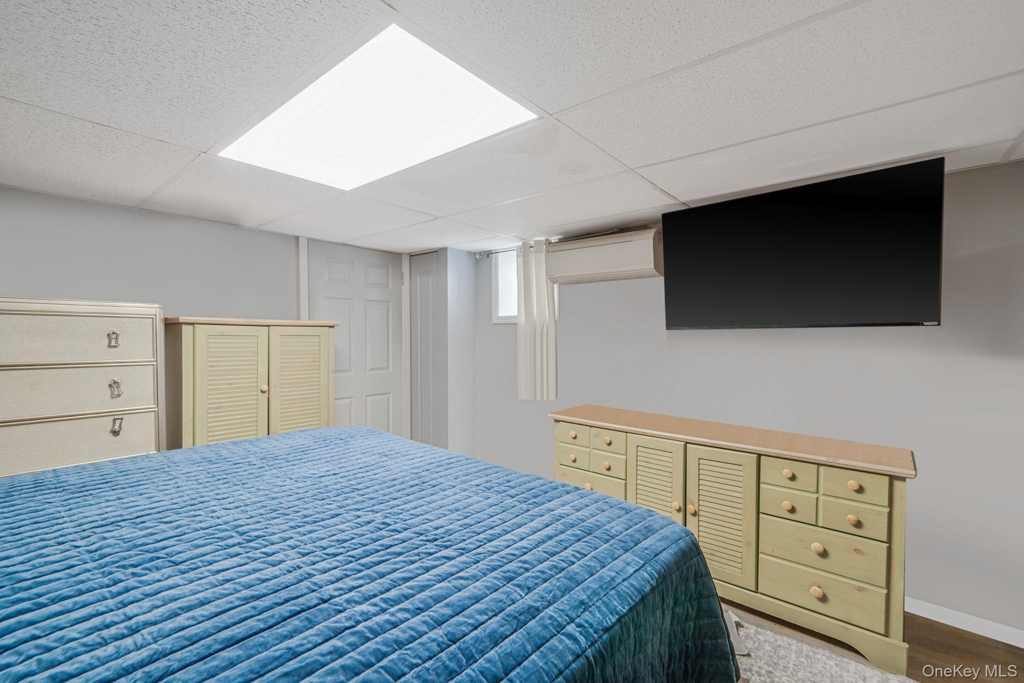85 Applegate Drive Central Islip, NY 11722 - Photo 25 of 33 a bedroom with a bed and a flat screen tv