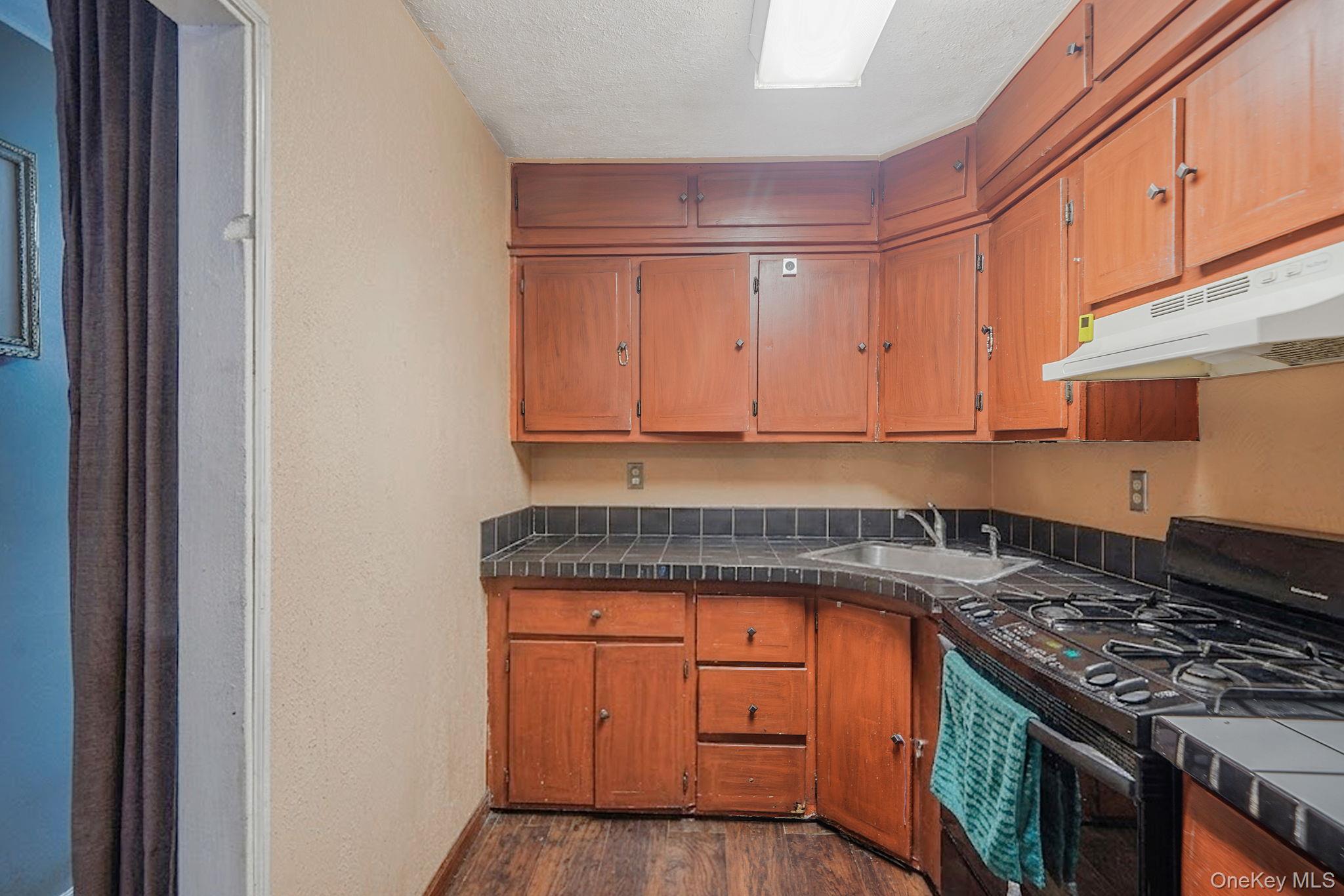 85 Applegate Drive Central Islip, NY 11722 - Photo 10 of 33 a kitchen with granite countertop a sink stove and cabinets