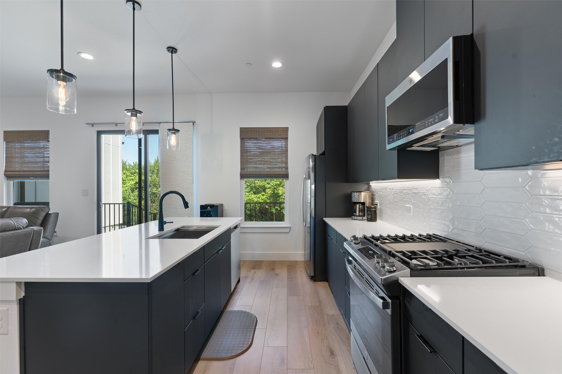 590 Old Mill Road, Unit 153 Cedar Park, TX 78613 - Photo 5 of 40 a kitchen with a sink stove and microwave