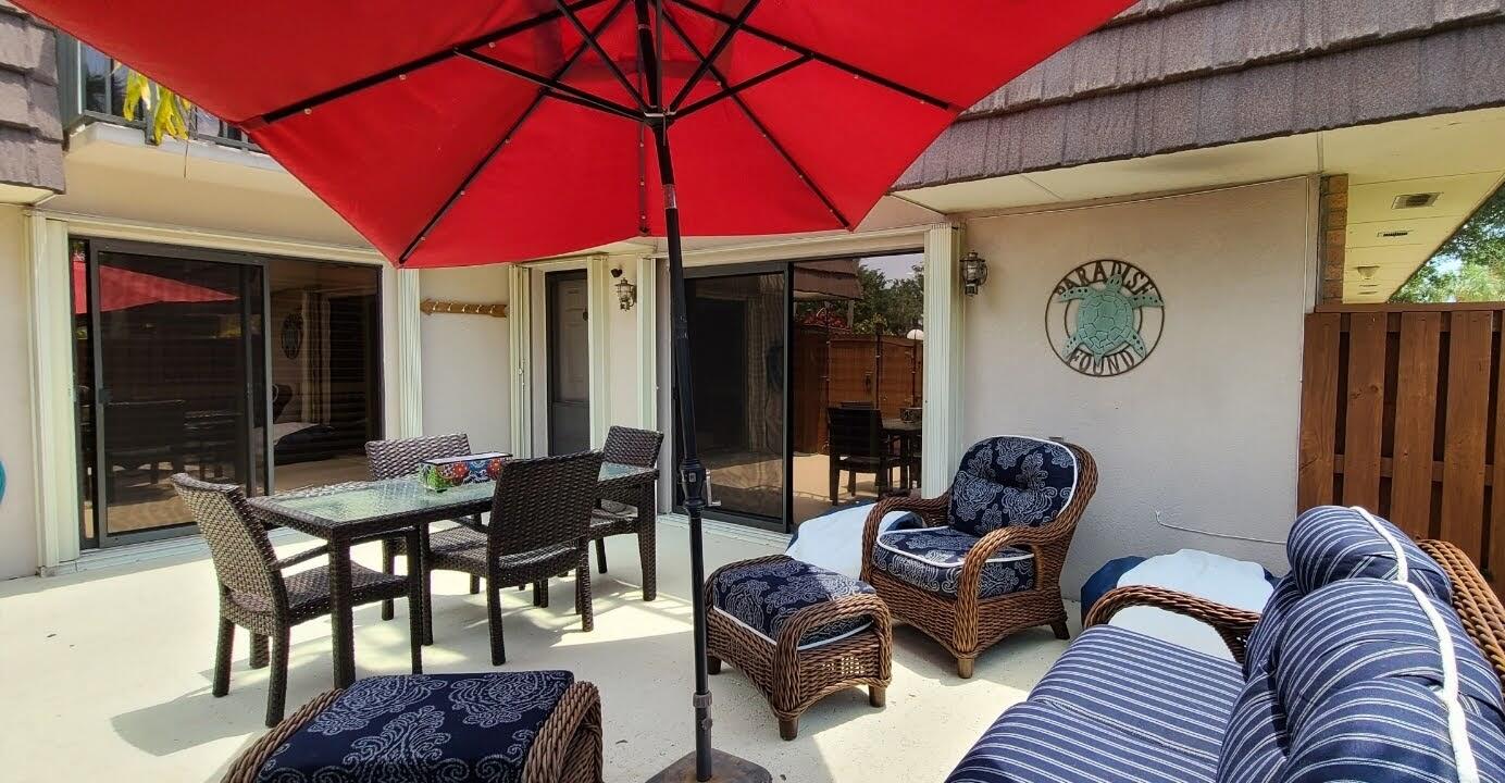a outdoor living space with furniture and umbrella
