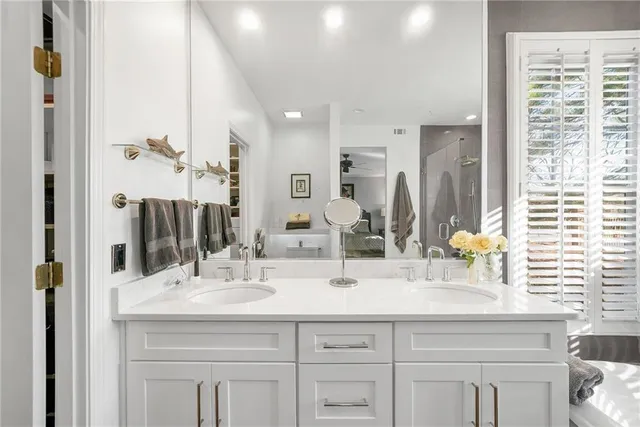 a bathroom with a sink double vanity and a mirror