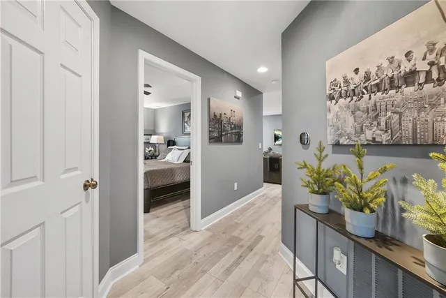 a hallway with wooden floor and furniture