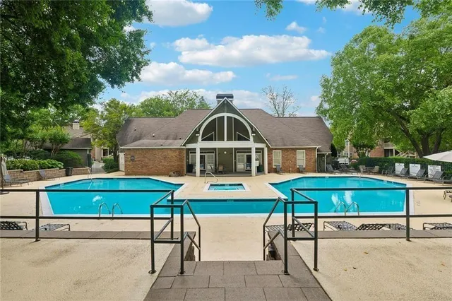 an aerial view of a house with swimming pool and furniture