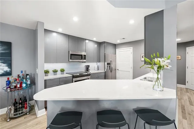a kitchen with a table a refrigerator and cabinets