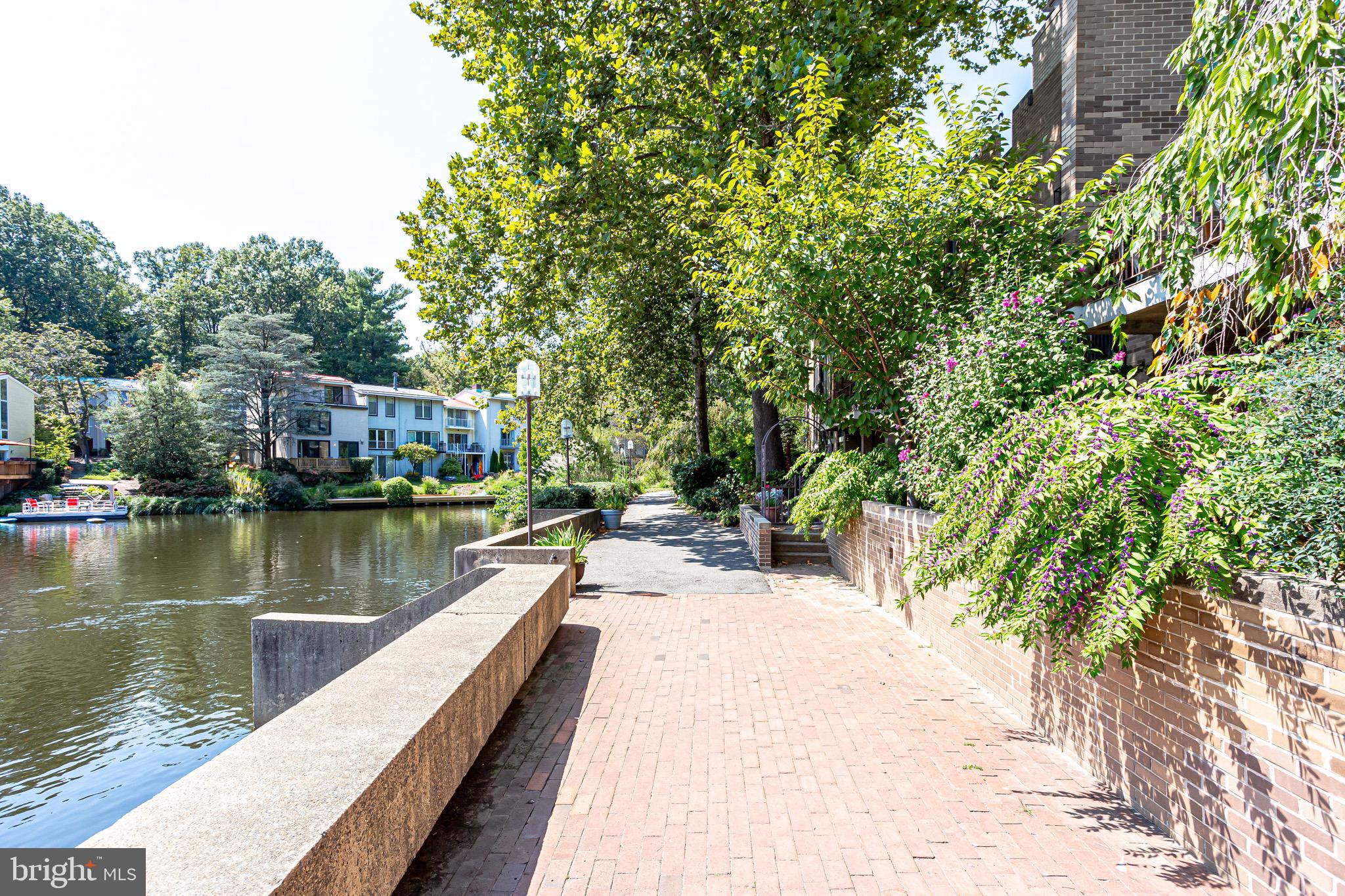 11400 Washington Plaza West, Unit 103 Reston, VA 20190 - Photo 11 of 57 a view of a lake with a house in the background