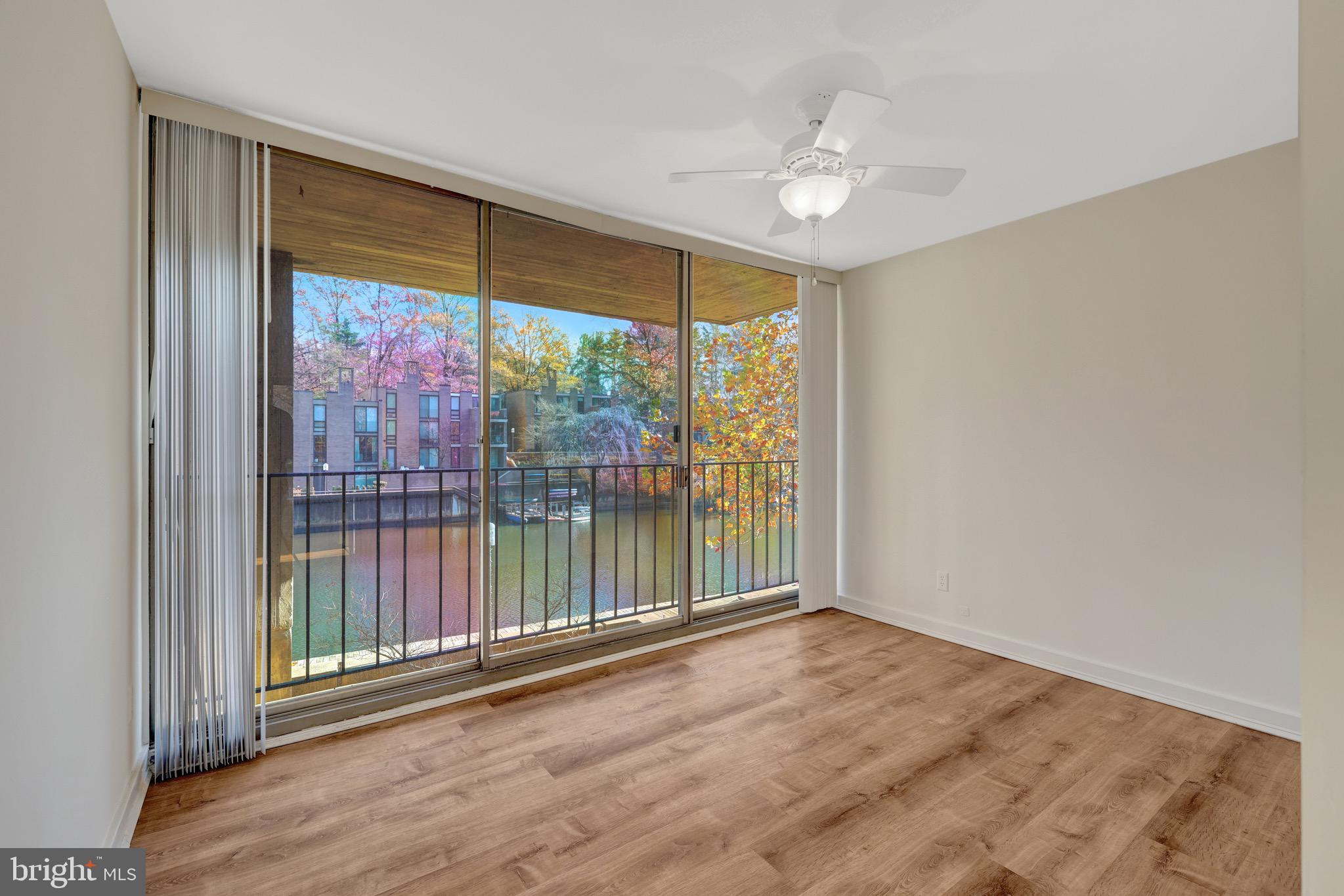 11400 Washington Plaza West, Unit 103 Reston, VA 20190 - Photo 15 of 57 wooden floor in an empty room with a window