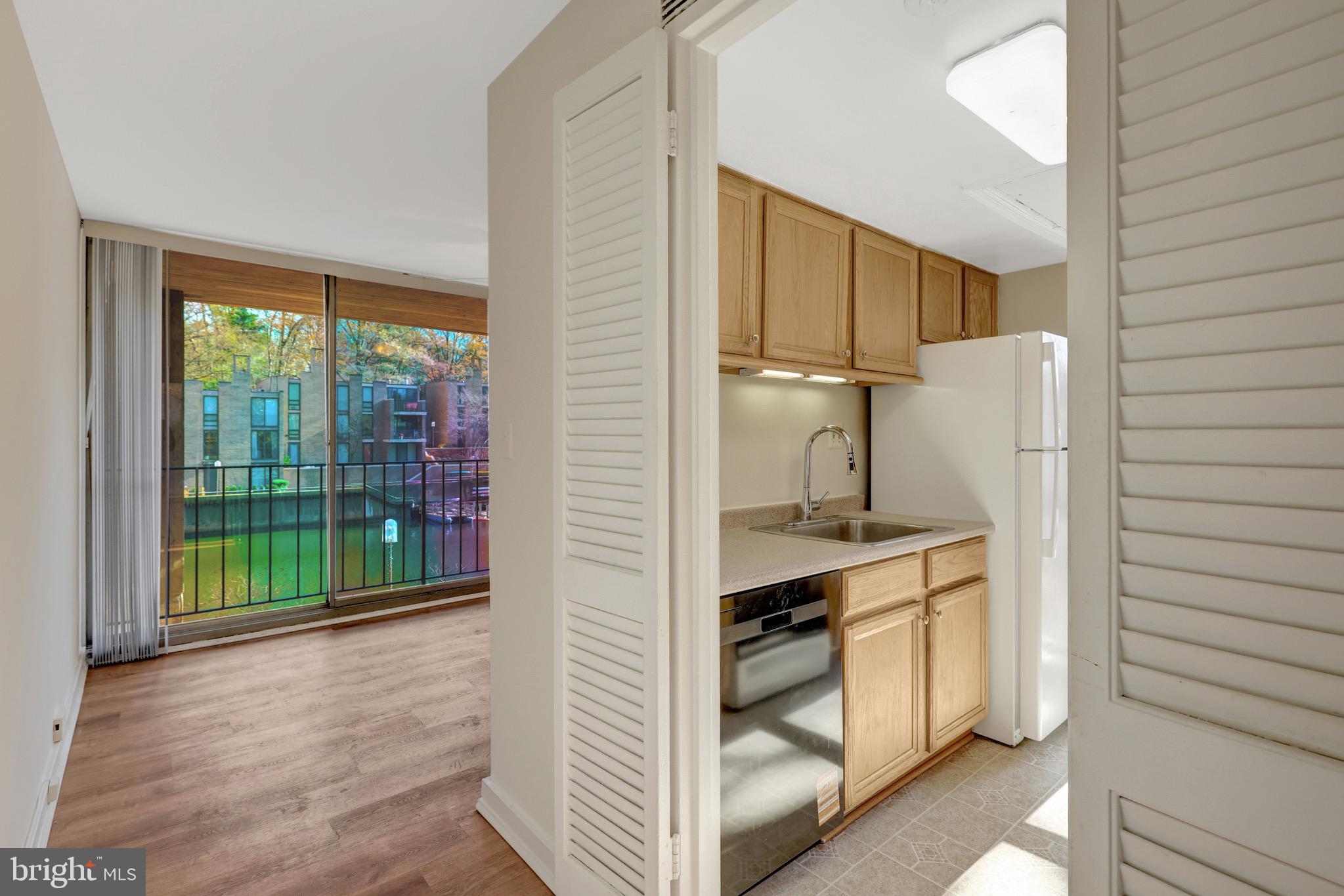 11400 Washington Plaza West, Unit 103 Reston, VA 20190 - Photo 21 of 57 a view of kitchen with cabinets and outdoor space