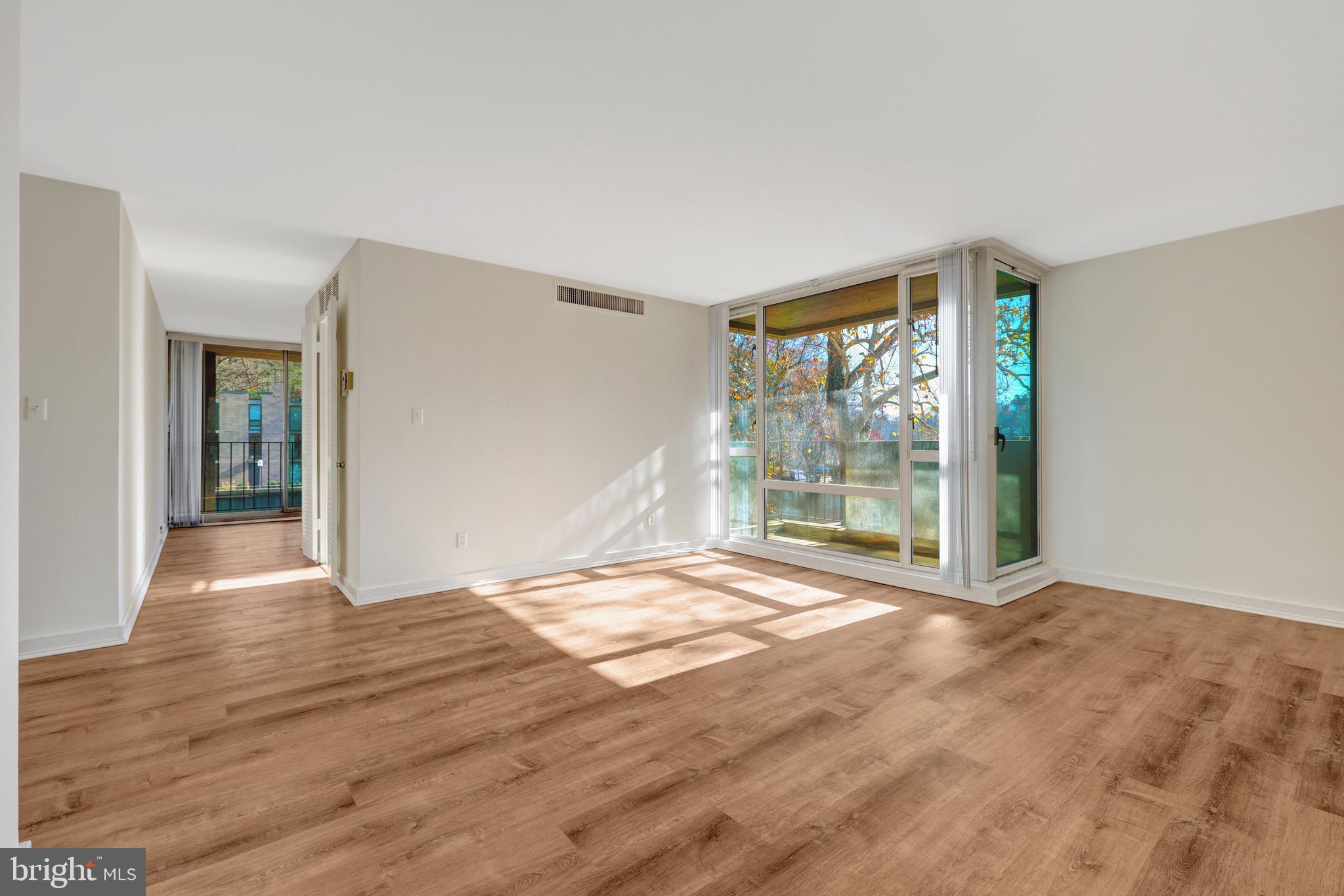 11400 Washington Plaza West, Unit 103 Reston, VA 20190 - Photo 29 of 57 a view of an empty room with wooden floor and a window