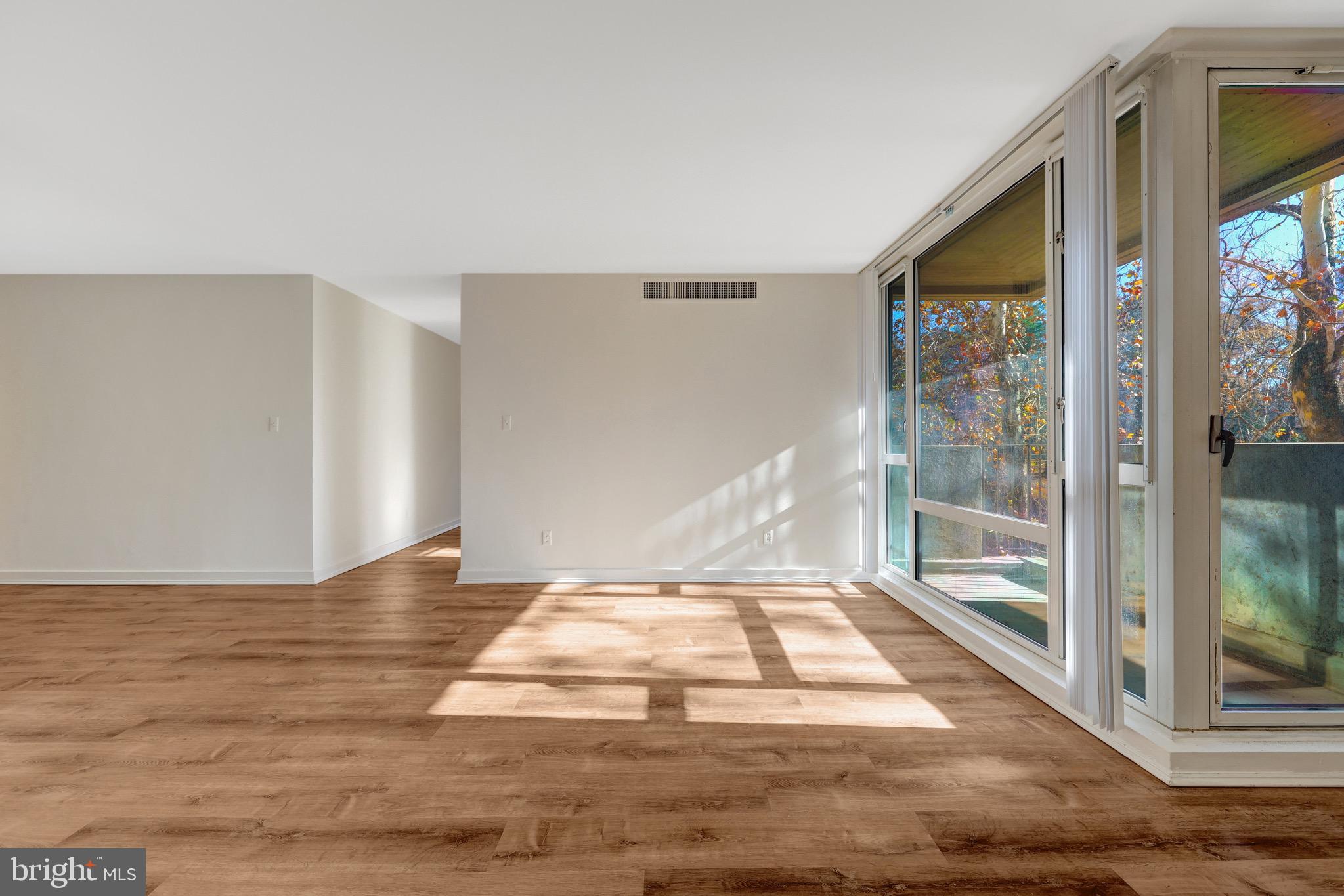 11400 Washington Plaza West, Unit 103 Reston, VA 20190 - Photo 30 of 57 a view of a livingroom with wooden floor and a balcony