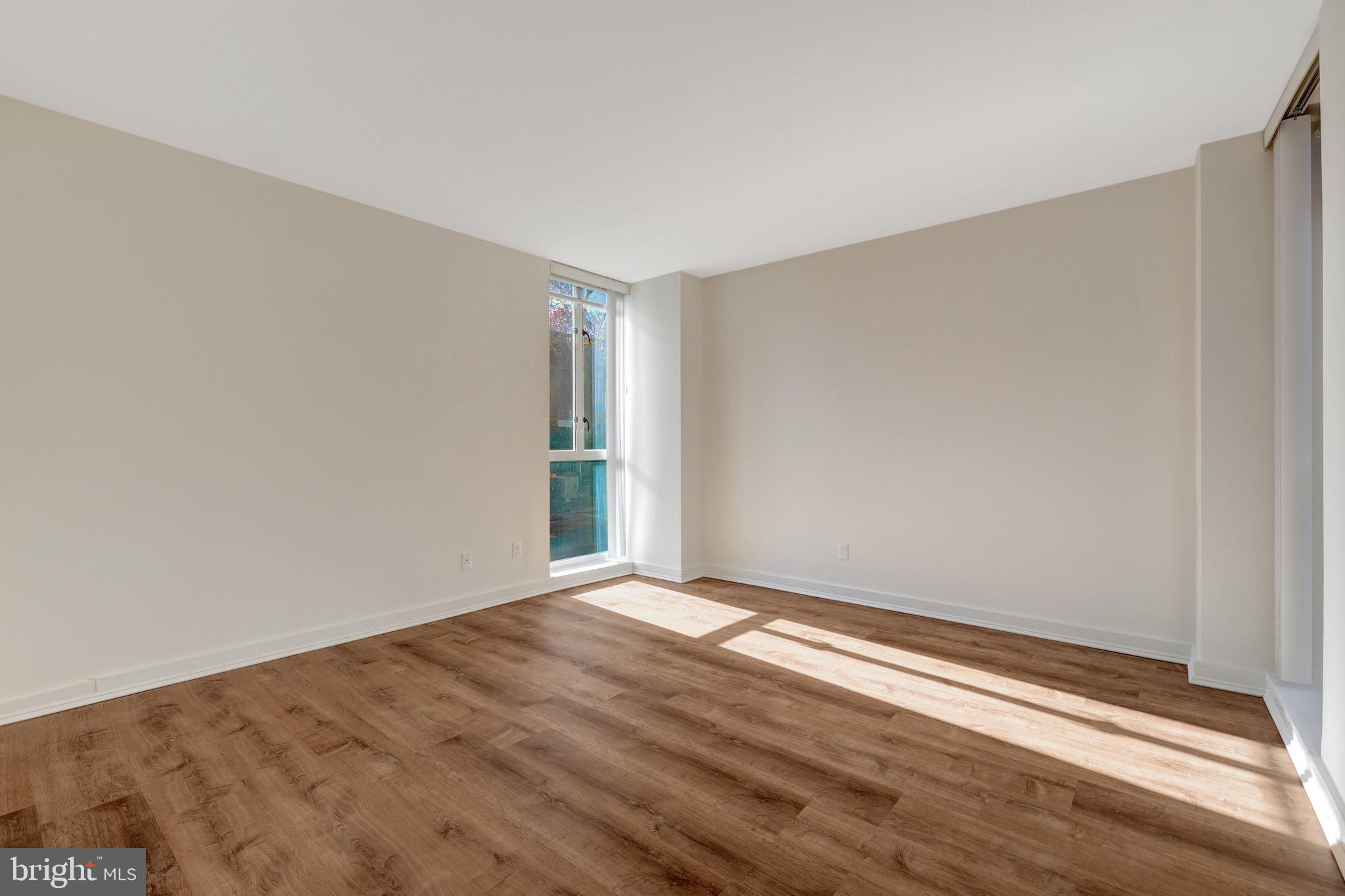 11400 Washington Plaza West, Unit 103 Reston, VA 20190 - Photo 38 of 57 a view of an empty room with wooden floor