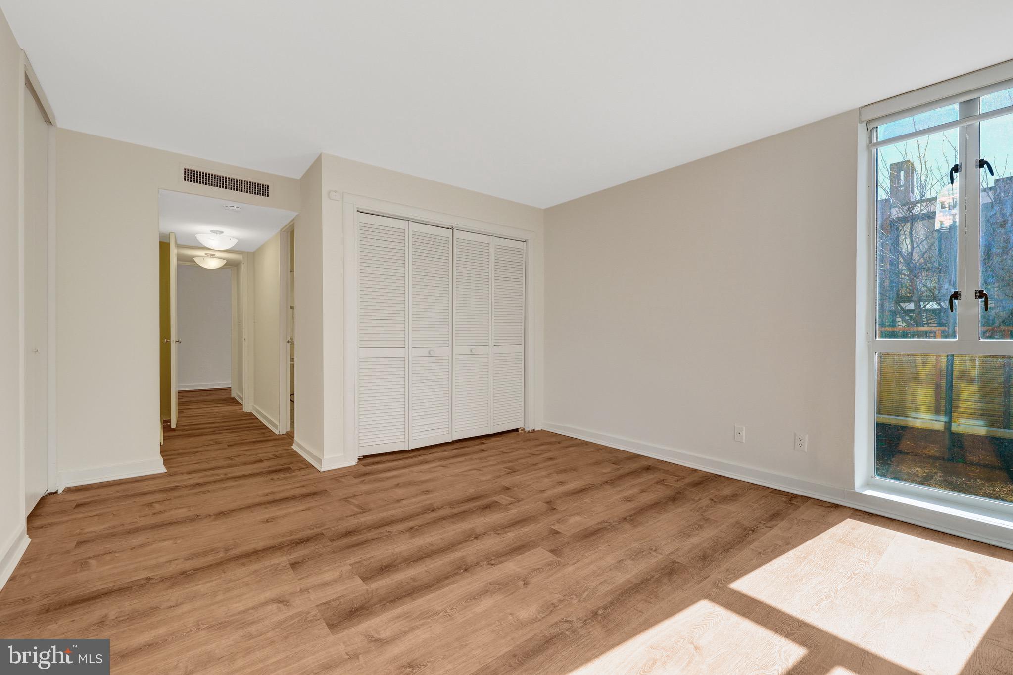 11400 Washington Plaza West, Unit 103 Reston, VA 20190 - Photo 39 of 57 a view of an empty room with wooden floor and a window
