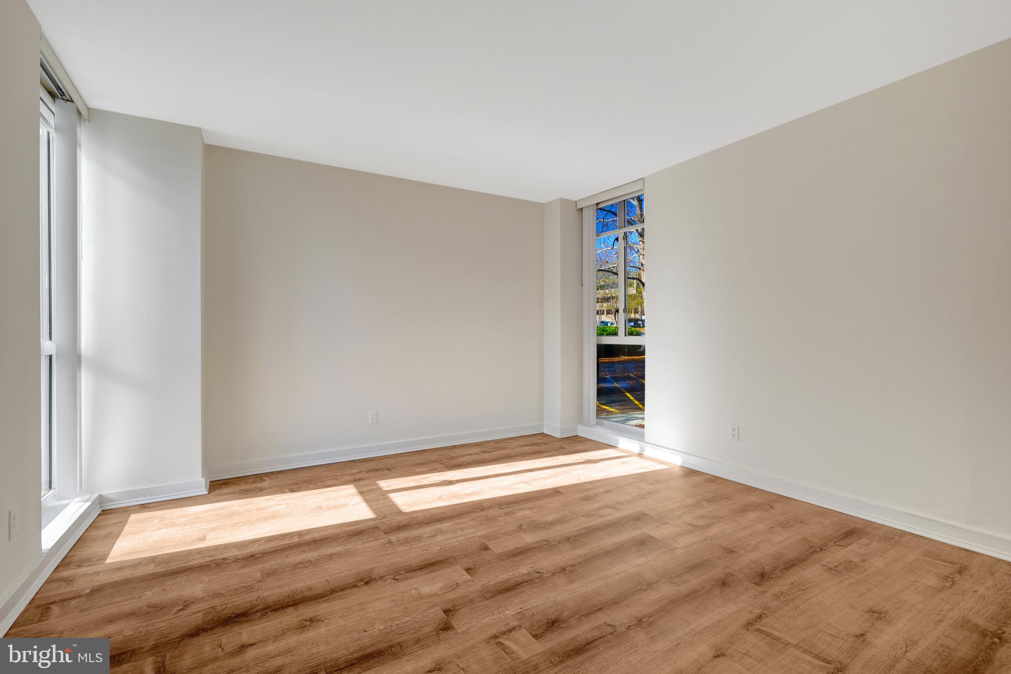 11400 Washington Plaza West, Unit 103 Reston, VA 20190 - Photo 40 of 57 a view of an empty room with wooden floor and a window