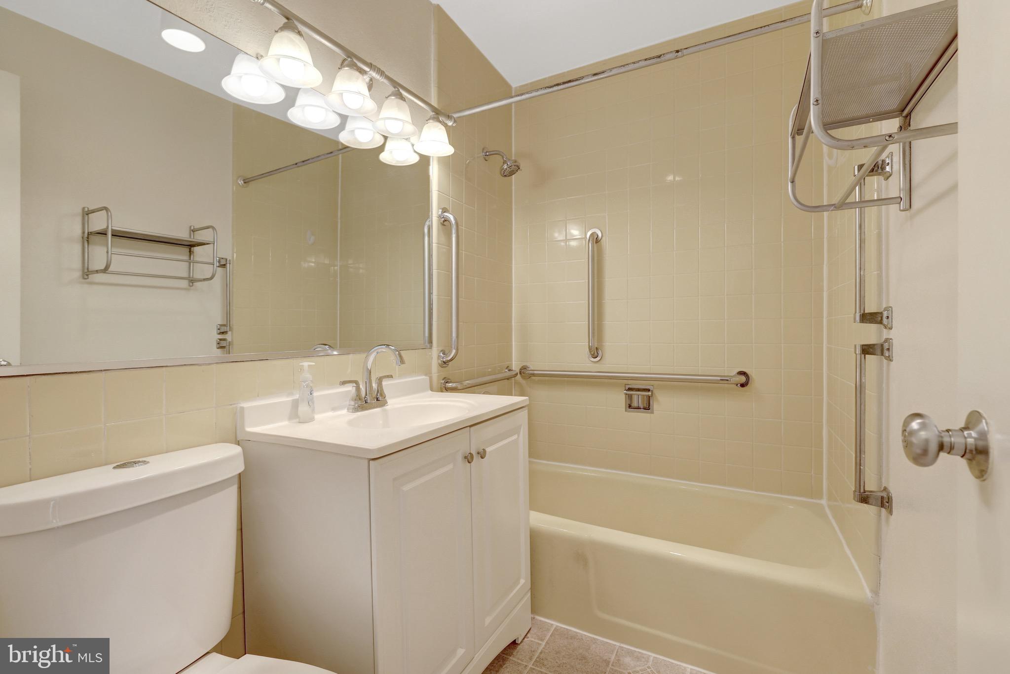 11400 Washington Plaza West, Unit 103 Reston, VA 20190 - Photo 41 of 57 a bathroom with a sink a toilet and shower