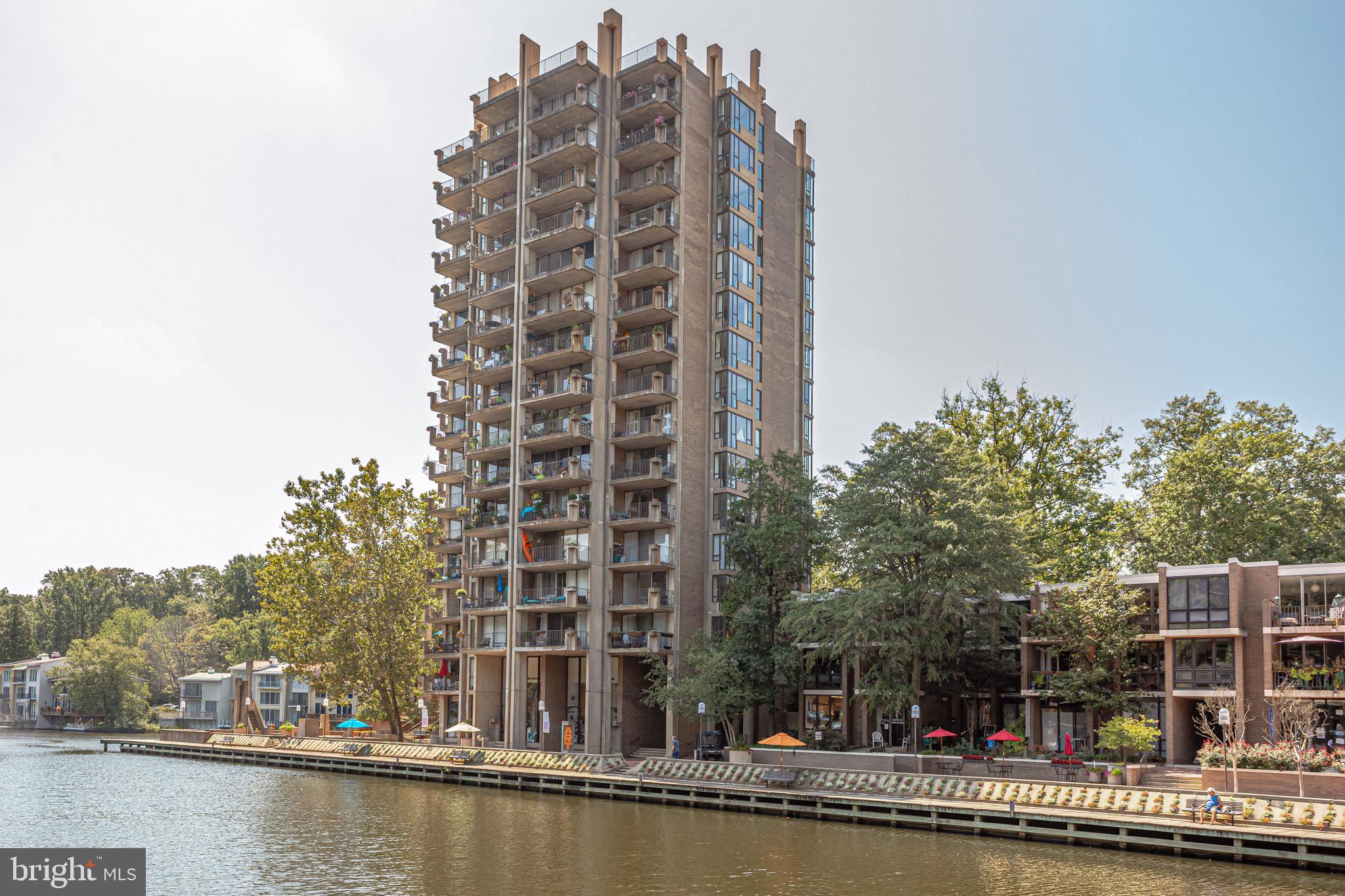 11400 Washington Plaza West, Unit 103 Reston, VA 20190 - Photo 47 of 57 a view of a tall building next to a lake