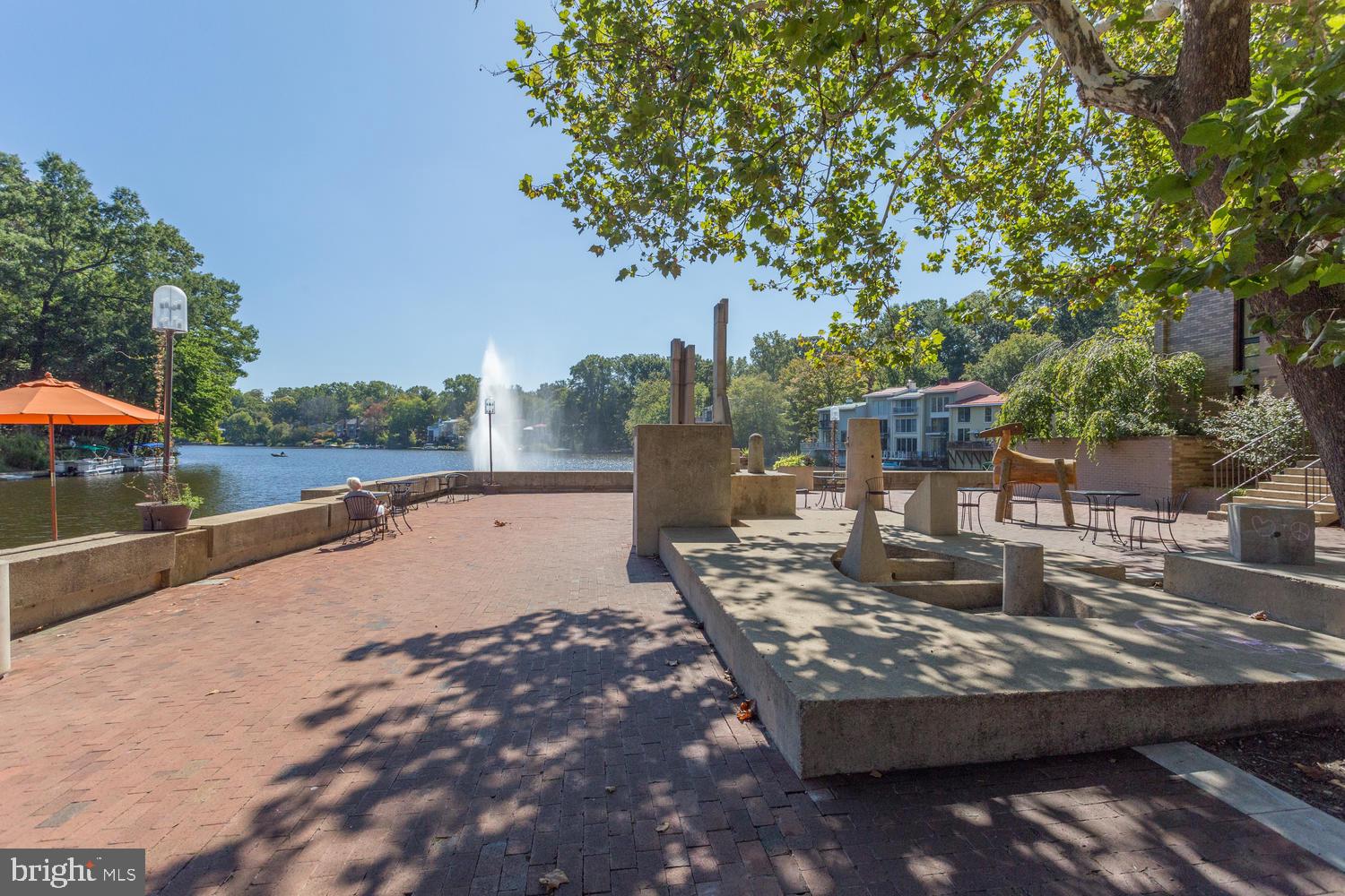 11400 Washington Plaza West, Unit 103 Reston, VA 20190 - Photo 53 of 57 a view of a swimming pool with a patio and a yard