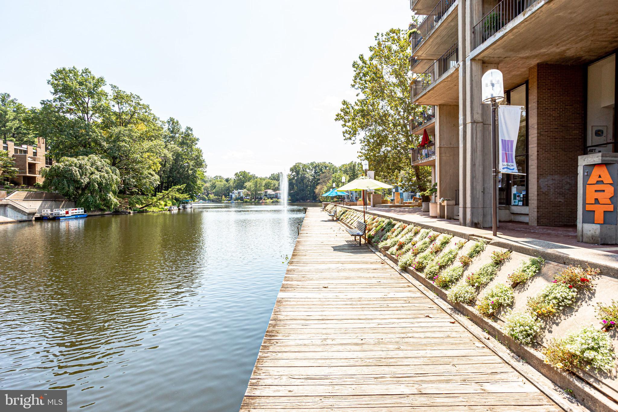 11400 Washington Plaza West, Unit 103 Reston, VA 20190 - Photo 10 of 57 a swimming pool with outdoor seating