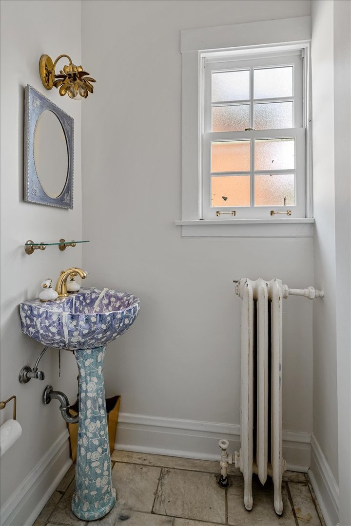 411 Sheridan Road Wilmette, IL 60091 - Photo 11 of 43 a bathroom with a sink and a mirror