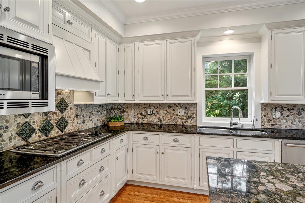 411 Sheridan Road Wilmette, IL 60091 - Photo 15 of 43 a kitchen with granite countertop white cabinets and window