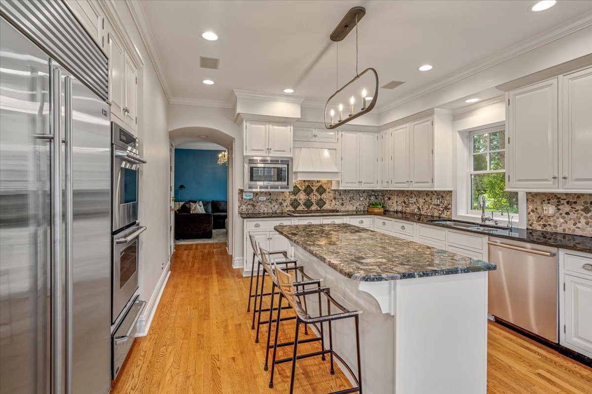 411 Sheridan Road Wilmette, IL 60091 - Photo 16 of 43 a kitchen with stainless steel appliances granite countertop a sink a stove and a refrigerator