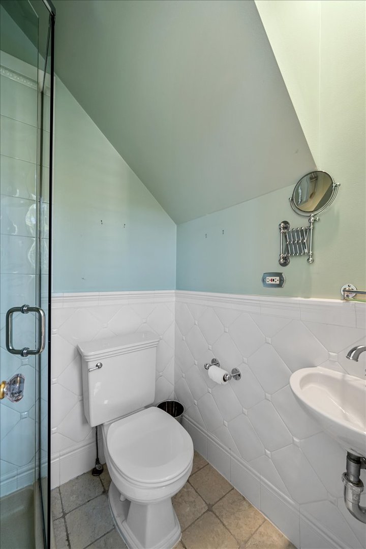 411 Sheridan Road Wilmette, IL 60091 - Photo 18 of 43 a bathroom with a granite countertop toilet sink and mirror