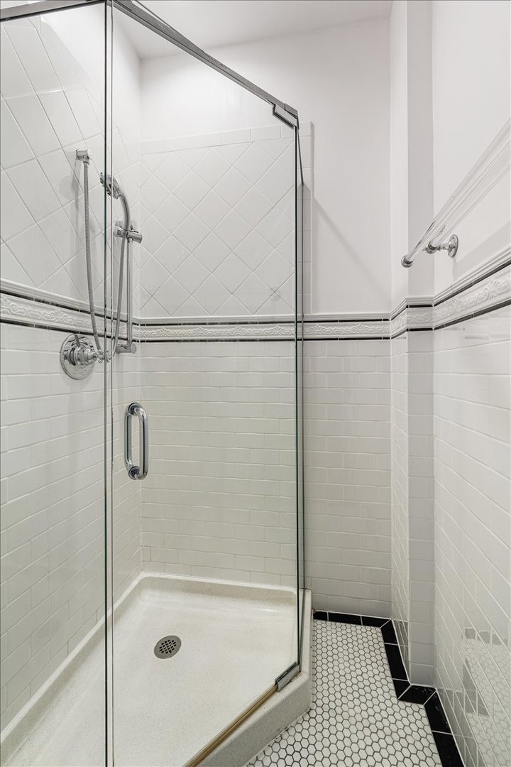 411 Sheridan Road Wilmette, IL 60091 - Photo 29 of 43 a bathroom with a glass shower door